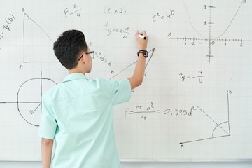 Premium Photo | Schoolboy in glass writing geometry equation on ...