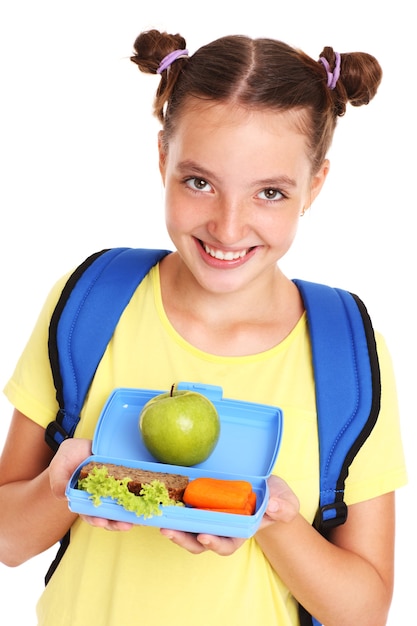 Premium Photo | A schoolgirl eating healthy lunch over white background