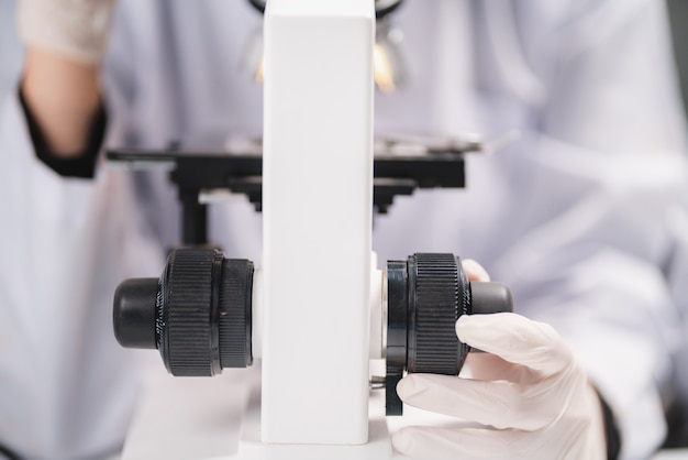 Premium Photo Scientist Looking Through Scientific Microscope Lense