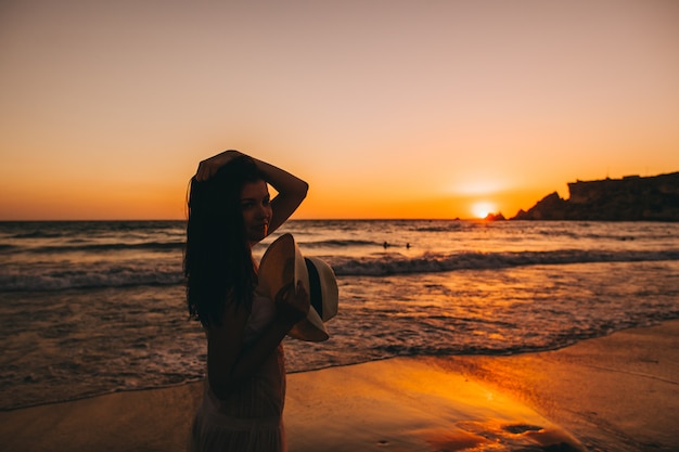 Premium Photo | Sea beach girl silhouette, sunset