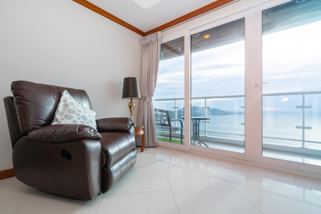 Sea view condo with sofa by the balcony Premium Photo
