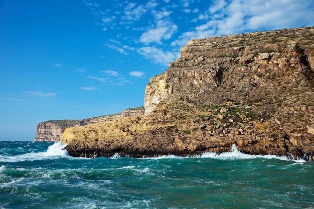 Sea wave breaking against coast  cliff Free Photo