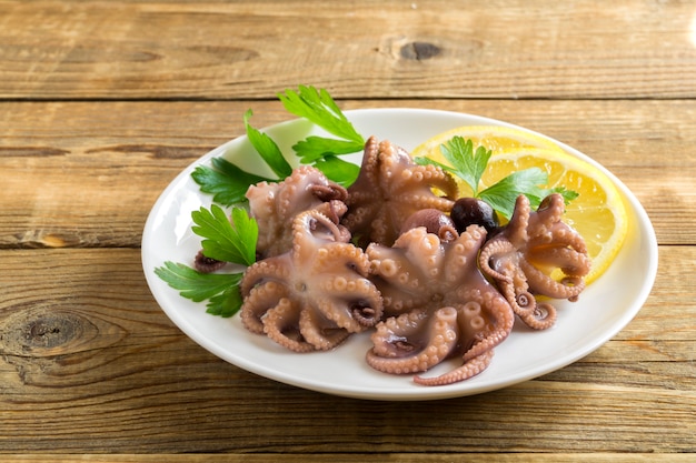 Premium Photo | Seafood. pickled baby octopus with lemon.