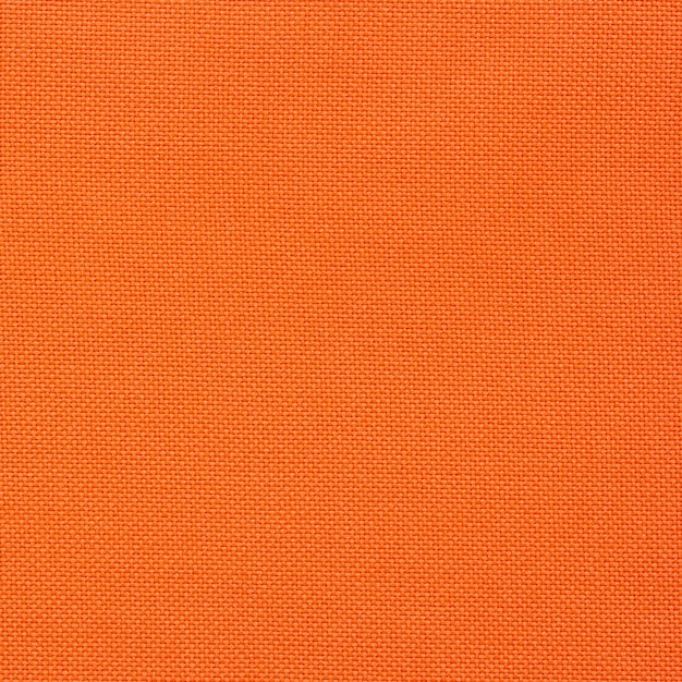 シームレスなオレンジ色のキャンバスのテクスチャ 無料の写真