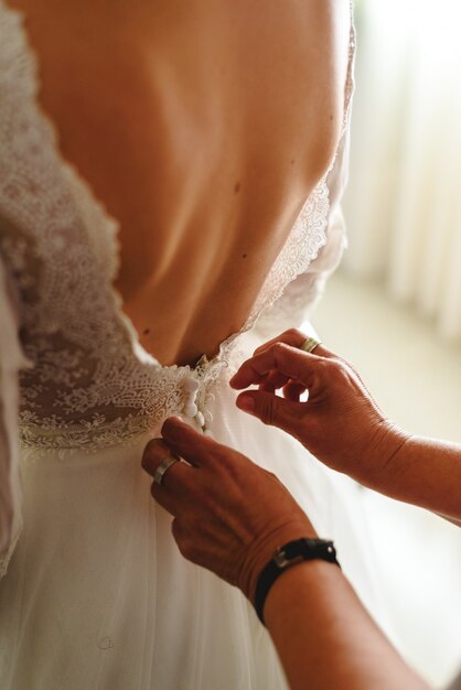 Seamstress Buttoning The Pretty Wedding Dress Elegant And Bare