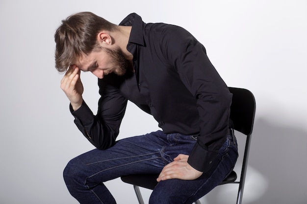 Premium Photo | Seated bearded young man looking worried