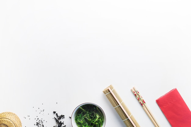 Free Photo | Seaweed salad near chopsticks and bamboo napkin