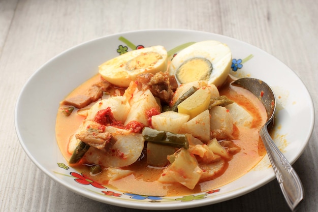 Premium Photo | Selected focus lontong sayur padang, vegetable curry ...