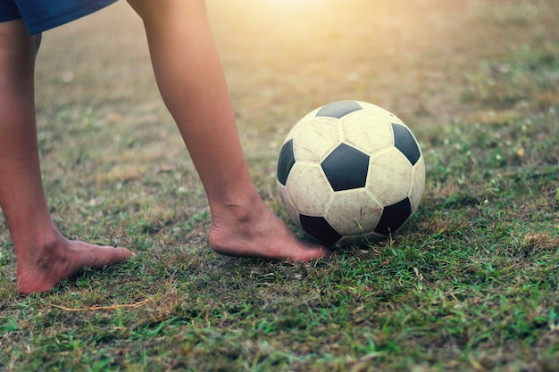 Premium Photo | Selective focus children feet play and soccer ball on field