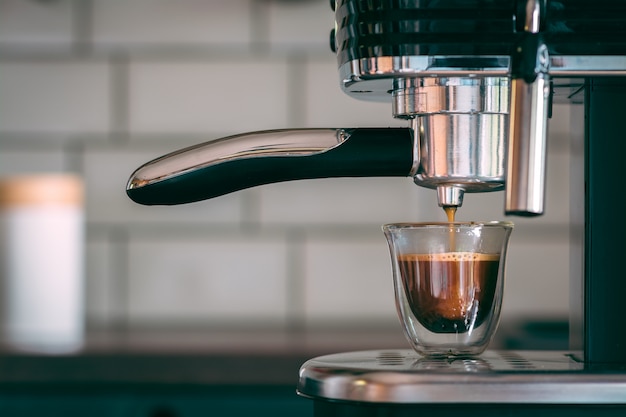 Selective focus shot of an espresso machine making tasty warm coffee in the morning Free Photo