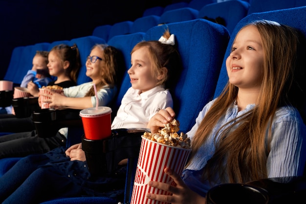 Free Photo | Selective focus of smiling little girl holding popcorn ...