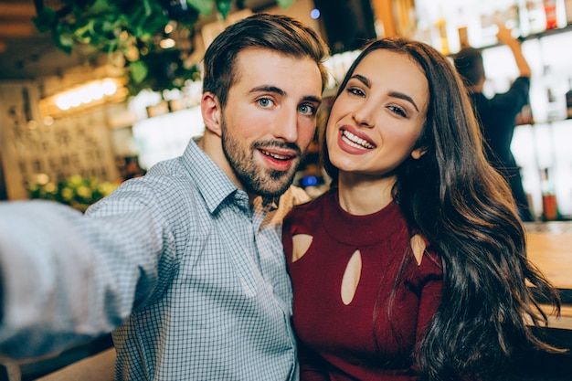 Premium Photo | Selfie of two beautiful people sitting together in a