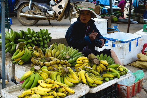 Selling bananas at asian market Photo | Free Download