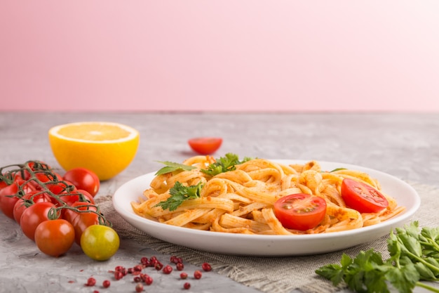 Premium Photo | Semolina pasta with tomato pesto sauce, orange and