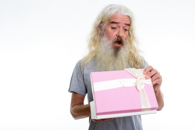 Premium Photo Senior Bearded Man Opening Gift Box While Looking At Gift