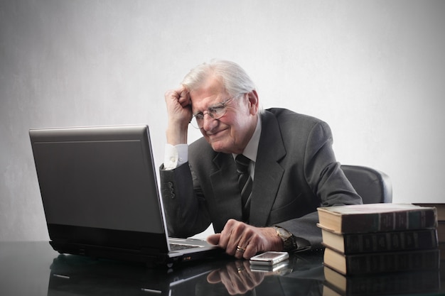Senior businessman working on a laptop Premium Photo