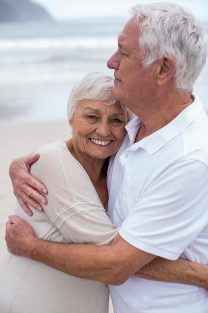 Premium Photo Senior Couple Embracing Each Other On The Beach 