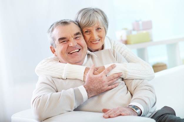 Senior couple hugging at home Free Photo