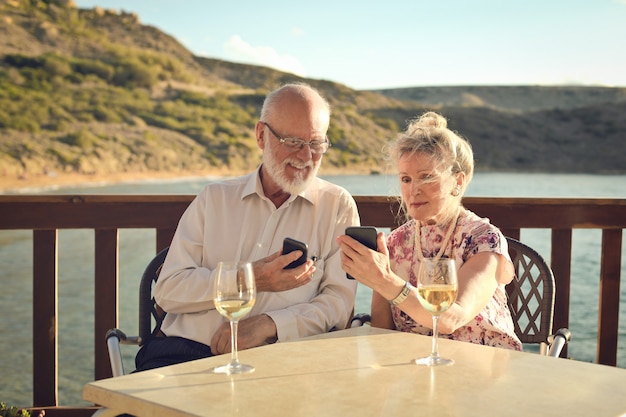 Senior couple using smartphone on a vacation Premium Photo