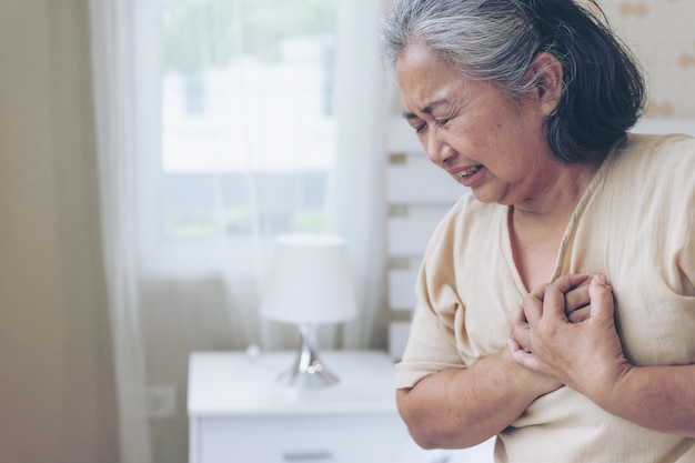 Free Photo | Senior female asian suffering from bad pain in his chest heart  attack at home - senior heart disease