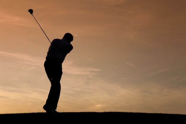 Premium Photo | Senior male golf player at sunset