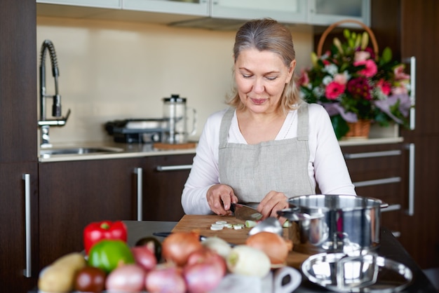 Premium Photo | Senior woman in kitchen preparing food