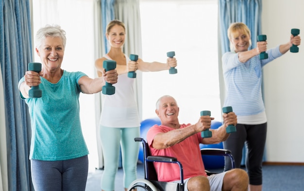 Premium Photo | Seniors exercising with weights