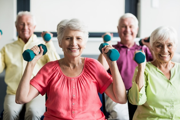 Premium Photo | Seniors using weights