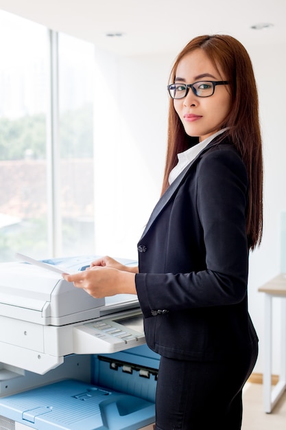 Serious Asian Businesswoman Copying Document Photo Free Download