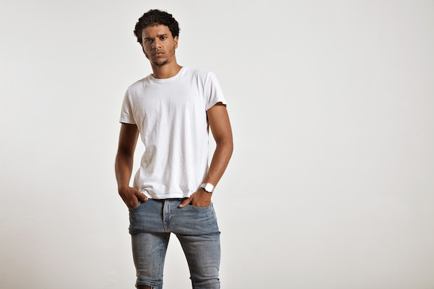 Free Photo | Serious young african american model with hands the pockets of his tight blue wearing a white t-shirt
