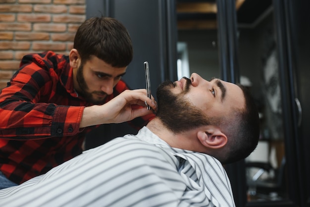 Premium Photo Serious Bearded Man Getting Beard Haircut With A