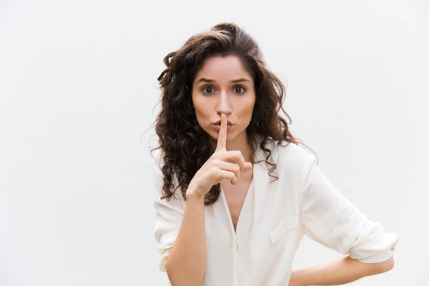 Free Photo | Serious concerned woman showing shh gesture