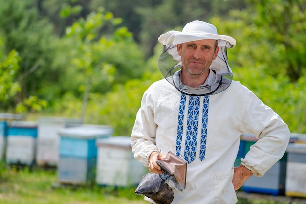 Premium Photo | Serious hard working beekeper poses to the camera at ...