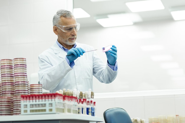 Premium Photo | Serious mature microbiologist working in modern clinic