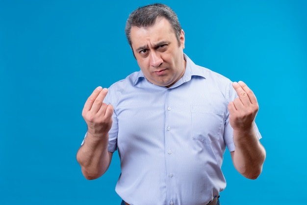 Free Photo Serious Middle Age Man In Blue Striped Shirt Gesturing