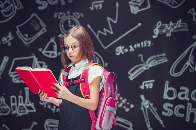 premium-photo-serious-pupil-in-glasses-preparing-to-go-to-school-with