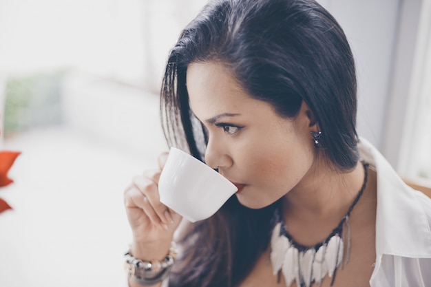 Free Photo | Serious woman drinking from a cup of coffee