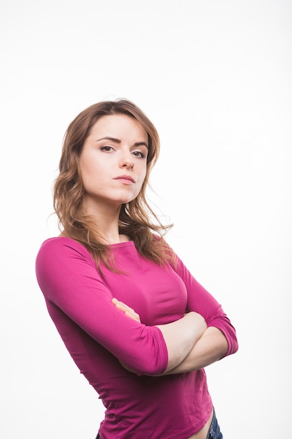 Free Photo Serious Young Woman With Her Arms Crossed Looking At Camera