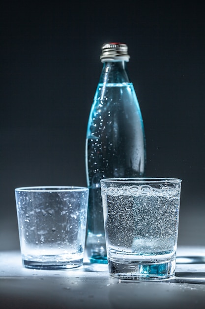 Premium Photo | Served table set of mineral water bottle and glass