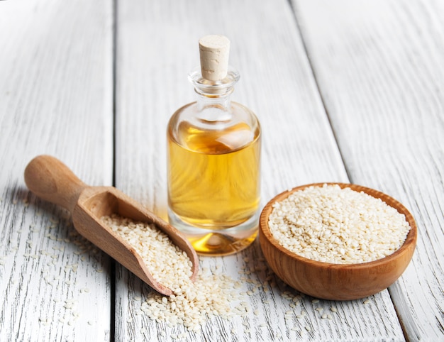 Premium Photo | Sesame seeds and bottle with oil