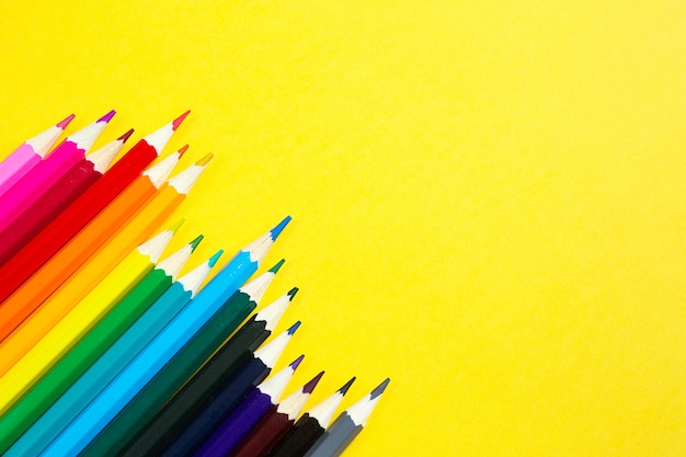 Premium Photo | Set of colorful pencils on a yellow background.