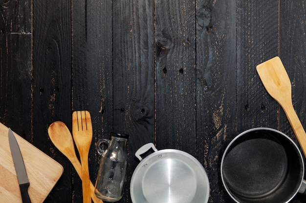 Premium Photo | Set of kitchenware on the black wooden background