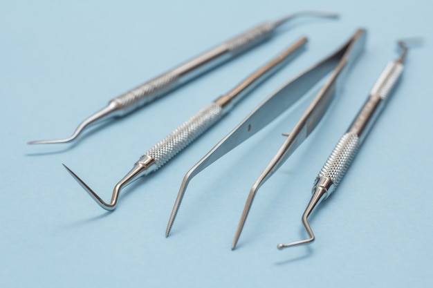 Premium Photo | Set of metal dental instruments for dental treatment ...