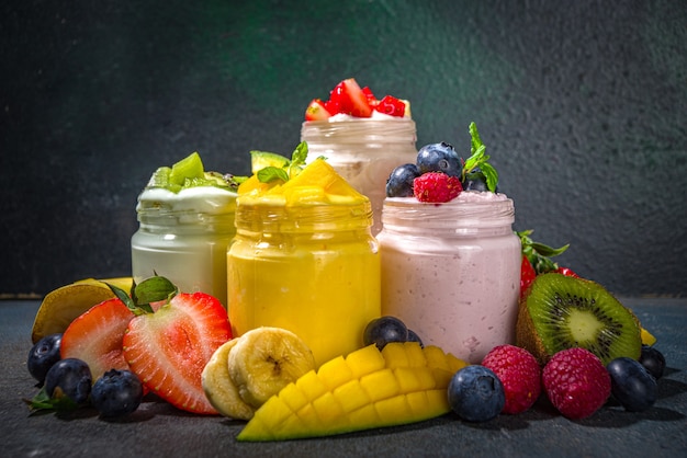 Premium Photo | Set of various fruit and berry sweet yogurts in glass ...