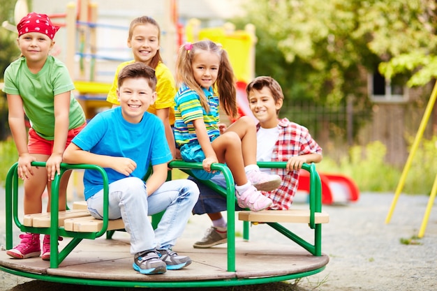 Several students having fun on the carousel Photo | Free Download