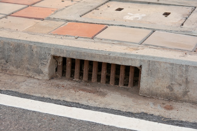 Premium Photo | Sewer drain along road in city