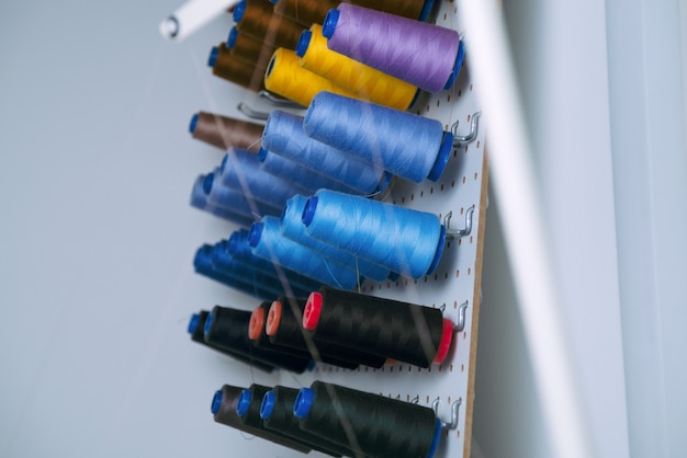 Premium Photo | Sewing machine spools with colorful threads