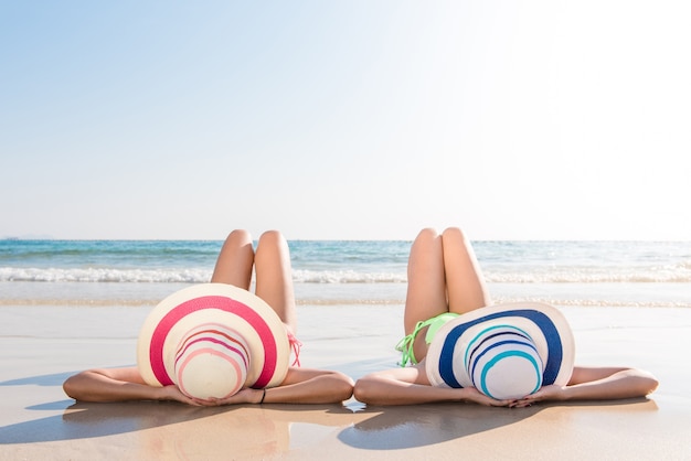 https://image.freepik.com/free-photo/sexy-bikini-body-asian-women-enjoy-sea-by-laying-down-sand-beach-wearing-millinery-hat-both-legs-up-air-happy-island-lifestyle-white-sand-crystal-sea-tropical-beach_1253-908.jpg