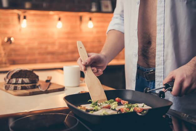 Premium Photo Sexy Guy Cooking In The Kitchen