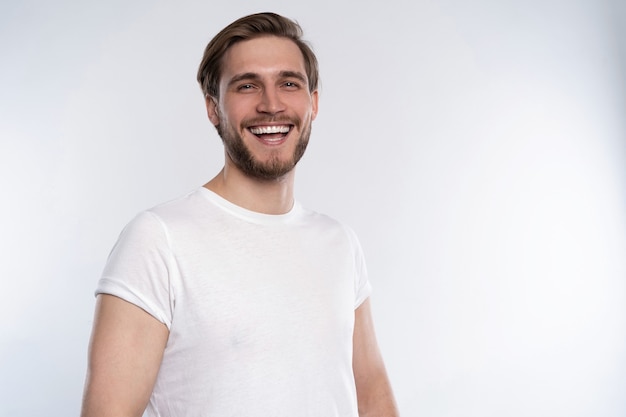 Premium Photo | Sexy smiling handsome man in white t-shirt isolated on ...